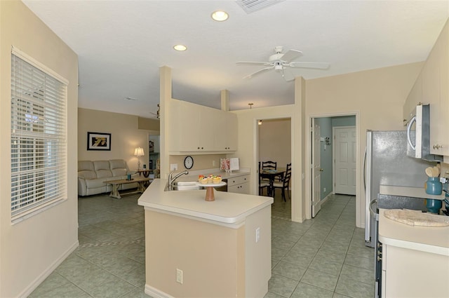 kitchen featuring stainless steel microwave, a ceiling fan, a sink, and light tile patterned floors