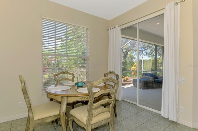 dining room featuring light tile patterned floors and baseboards