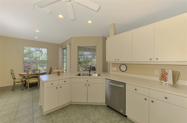 kitchen featuring stainless steel dishwasher, a sink, light countertops, recessed lighting, and a peninsula