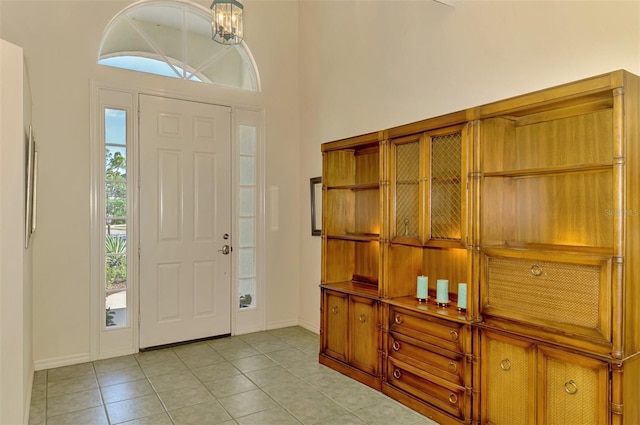 entrance foyer with light tile patterned flooring and baseboards