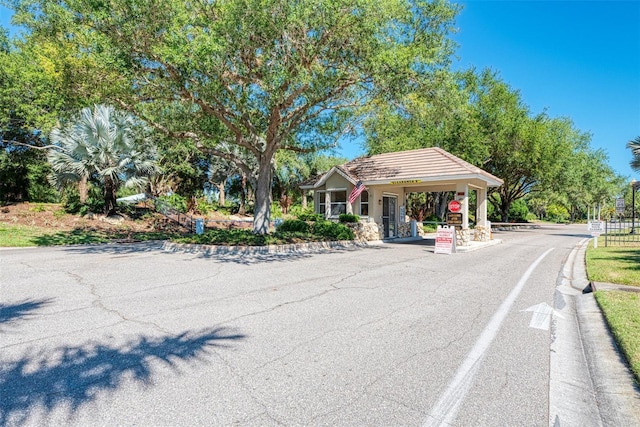 view of street with curbs and a gated entry