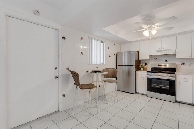360 Base Ave E Unit 413, Venice, FL 34285 - kitchen featuring ceiling fan, stainless steel appliances, white cabinetry, light countertops, and under cabinet range hood