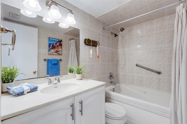 360 Base Ave E Unit 413, Venice, FL 34285 - full bathroom featuring vanity, tile walls, shower / bath combination with curtain, toilet, and visible vents