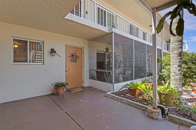 360 Base Ave E Unit 413, Venice, FL 34285 - doorway to property with a patio, a balcony, and stucco siding