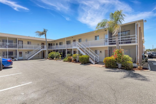 360 Base Ave E Unit 413, Venice, FL 34285 - view of building exterior with uncovered parking and stairway