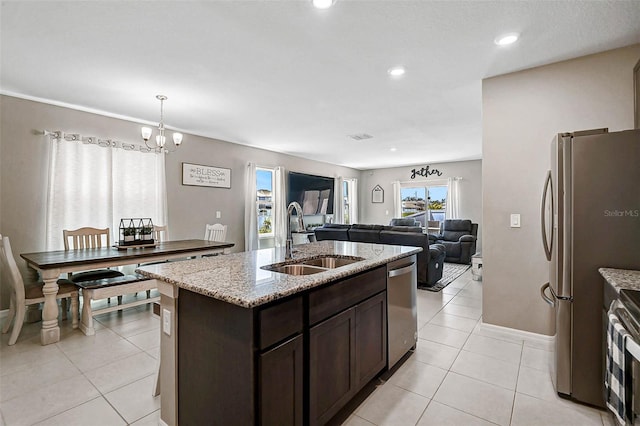 4523 Birdsong Dr, Palmetto, FL 34221 - kitchen featuring dark brown cabinets, stainless steel appliances, a sink, and light tile patterned flooring