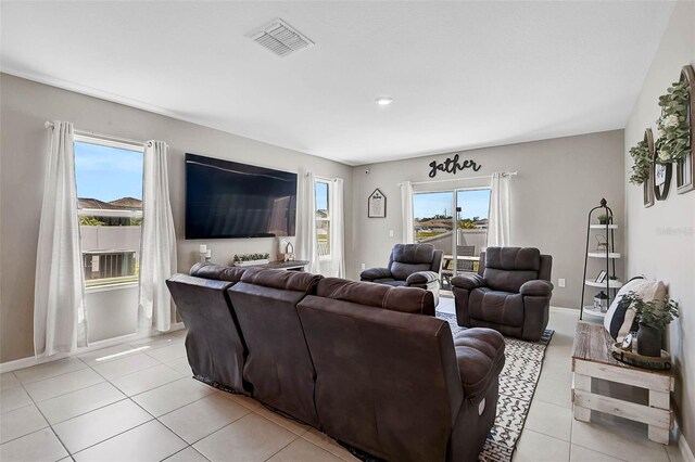 4523 Birdsong Dr, Palmetto, FL 34221 - living room featuring baseboards, visible vents, and light tile patterned floors