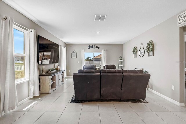 4523 Birdsong Dr, Palmetto, FL 34221 - living room with baseboards, visible vents, and light tile patterned flooring