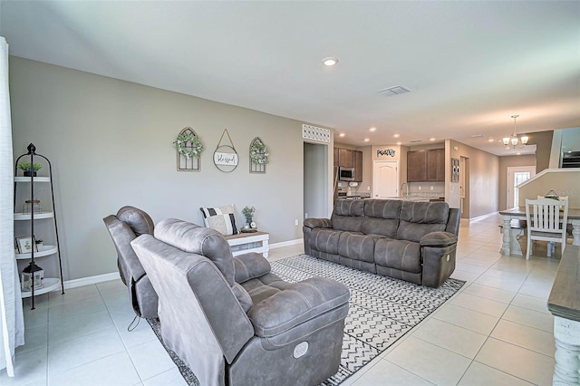 4523 Birdsong Dr, Palmetto, FL 34221 - living area featuring an inviting chandelier, visible vents, baseboards, and light tile patterned floors