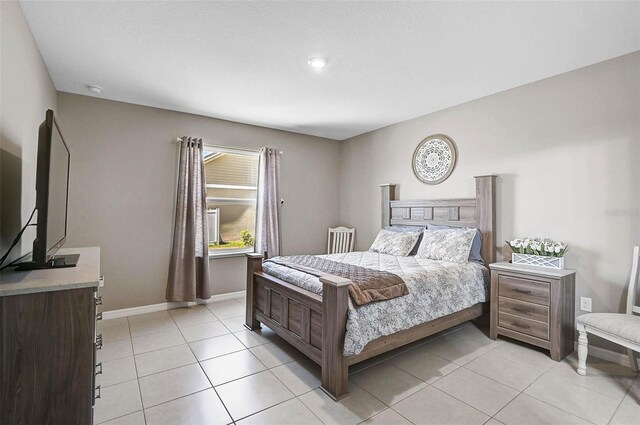 4523 Birdsong Dr, Palmetto, FL 34221 - bedroom with baseboards and light tile patterned flooring