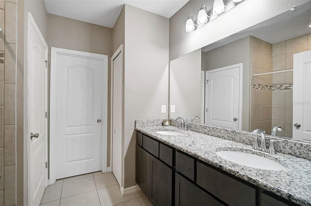 4523 Birdsong Dr, Palmetto, FL 34221 - bathroom with baseboards, tile patterned floors, a sink, and double vanity