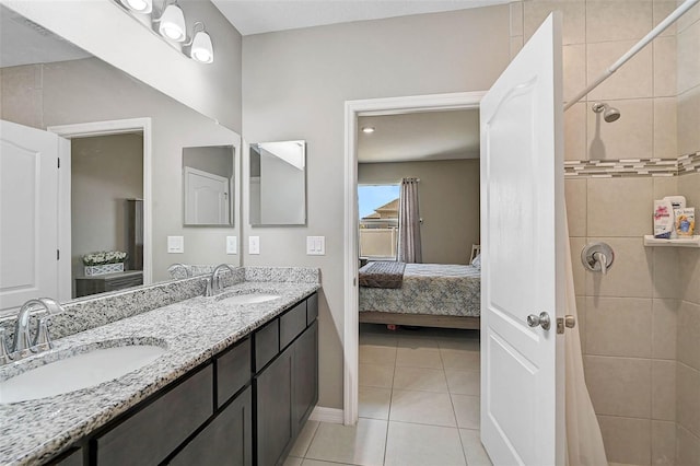 4523 Birdsong Dr, Palmetto, FL 34221 - ensuite bathroom featuring tile patterned flooring, a tile shower, a sink, and connected bathroom