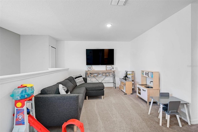 4523 Birdsong Dr, Palmetto, FL 34221 - living area featuring visible vents, a textured ceiling, recessed lighting, and light colored carpet