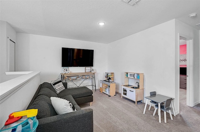 4523 Birdsong Dr, Palmetto, FL 34221 - living room featuring light colored carpet, baseboards, a textured ceiling, and visible vents