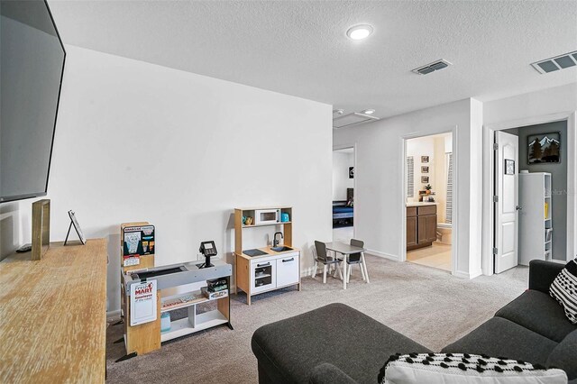 4523 Birdsong Dr, Palmetto, FL 34221 - living room featuring light carpet, a textured ceiling, and visible vents