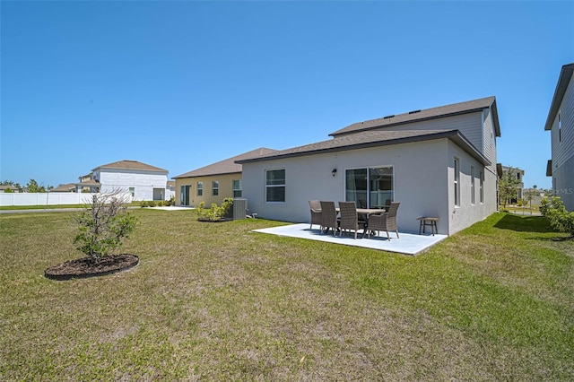4523 Birdsong Dr, Palmetto, FL 34221 - rear view of property featuring stucco siding, a yard, a patio, and central AC