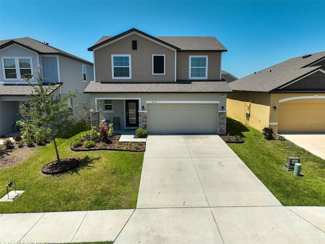 4523 Birdsong Dr, Palmetto, FL 34221 - view of front of home with a garage, stone siding, a front yard, and concrete driveway