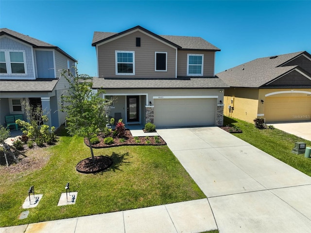 4523 Birdsong Dr, Palmetto, FL 34221 - craftsman-style house featuring roof with shingles, driveway, stone siding, a garage, and a front yard