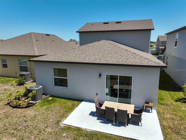 4523 Birdsong Dr, Palmetto, FL 34221 - rear view of house featuring central air condition unit, roof with shingles, a yard, and a patio