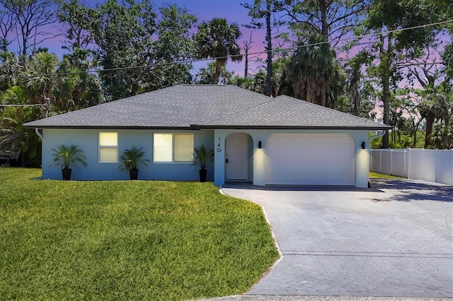 140 Hermes Rd, Venice, FL 34293 - ranch-style house with stucco siding, fence, a garage, driveway, and a front yard