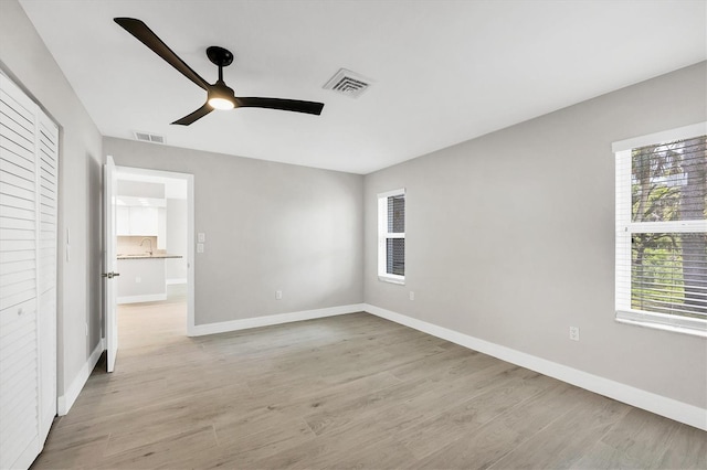 140 Hermes Rd, Venice, FL 34293 - unfurnished bedroom featuring visible vents, light wood-style flooring, multiple windows, and baseboards