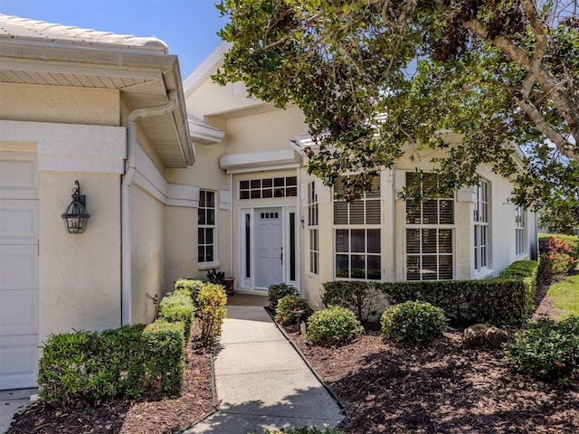 property entrance with stucco siding