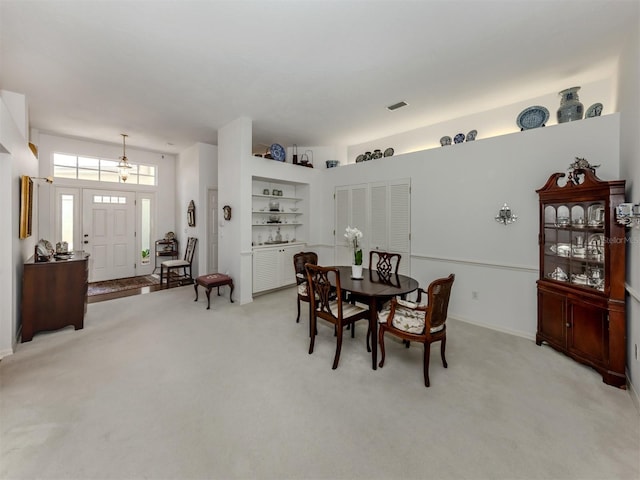 dining area featuring visible vents and light colored carpet