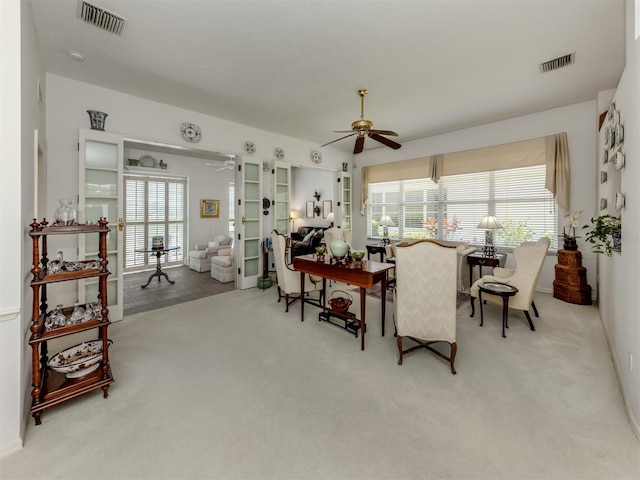living room with a healthy amount of sunlight, carpet, a ceiling fan, and visible vents