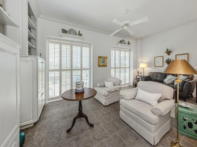 living area featuring ornamental molding and a ceiling fan