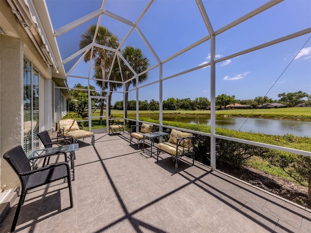 sunroom / solarium featuring a water view