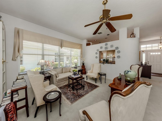 living area with carpet floors, ceiling fan, and visible vents