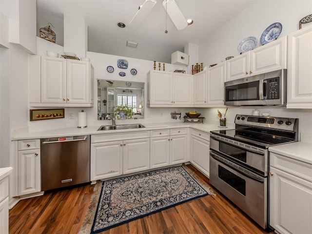 kitchen featuring white cabinets, ceiling fan, appliances with stainless steel finishes, a sink, and light countertops