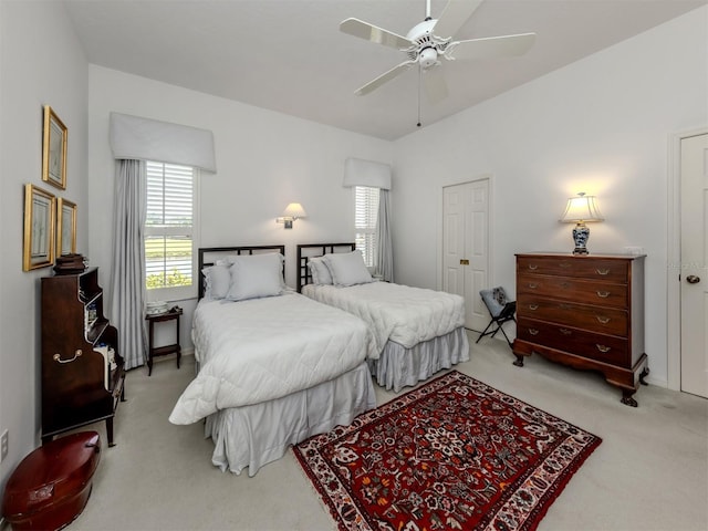bedroom featuring multiple windows, a ceiling fan, and carpet flooring