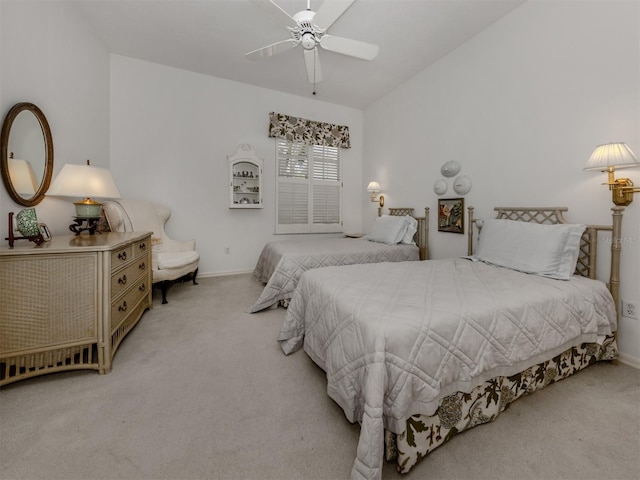 bedroom featuring baseboards, light colored carpet, ceiling fan, and vaulted ceiling