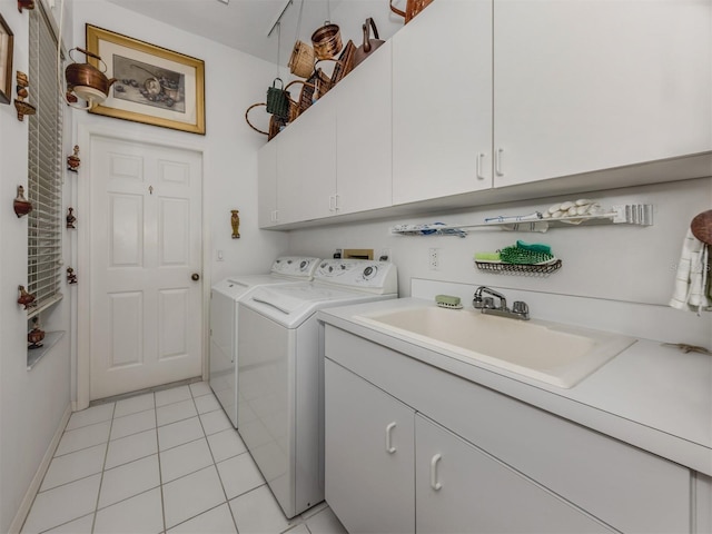 laundry room with a sink, cabinet space, light tile patterned floors, and washing machine and clothes dryer