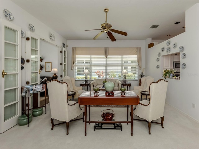 interior space featuring a ceiling fan, carpet flooring, and visible vents