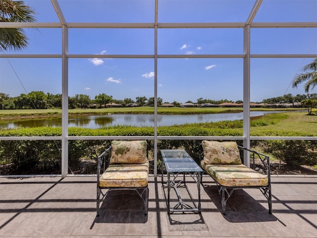 sunroom / solarium featuring a water view