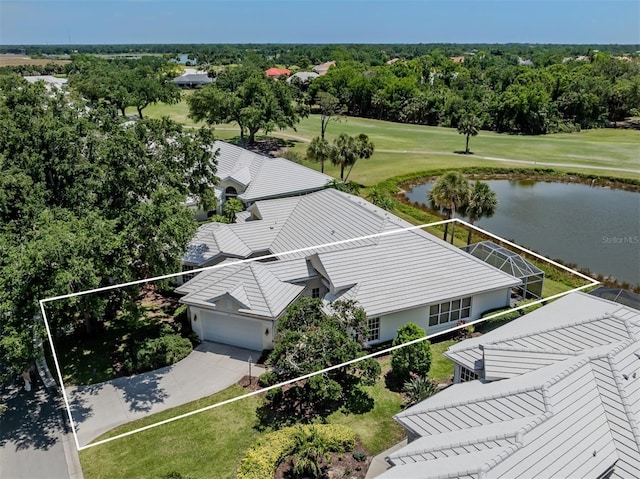 drone / aerial view with view of golf course and a water view