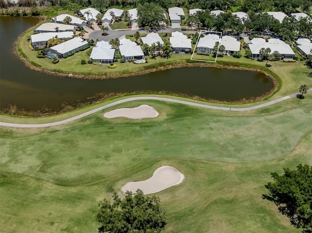 aerial view with a residential view, a water view, and golf course view