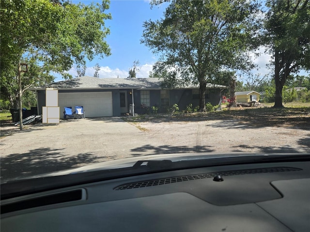 single story home with concrete driveway and a garage