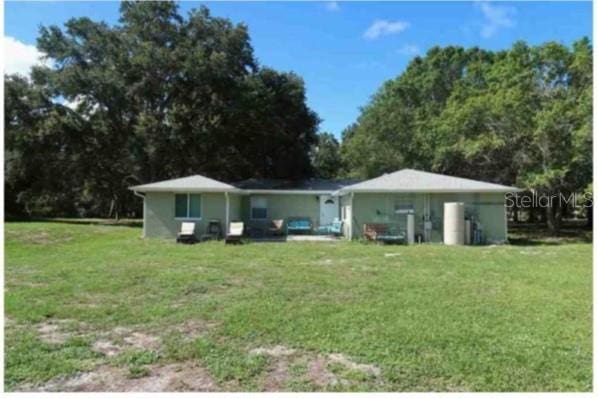 751 Arabian Cir, Nokomis, FL 34275 - back of house featuring a lawn