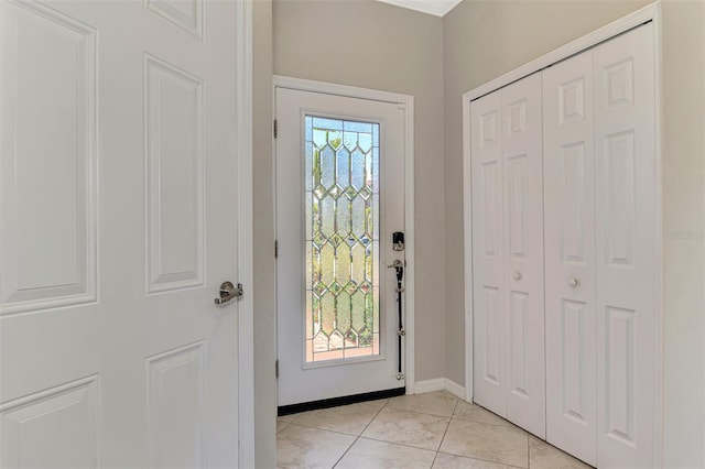 entrance foyer with baseboards and light tile patterned floors