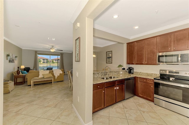kitchen featuring ceiling fan, appliances with stainless steel finishes, light stone countertops, open floor plan, and ornamental molding