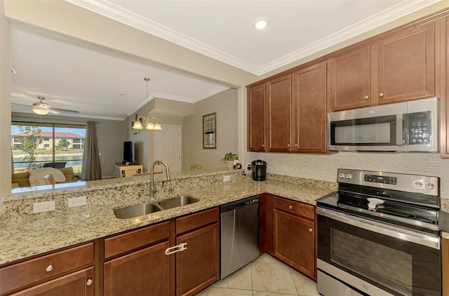 kitchen featuring ornamental molding, light stone countertops, a sink, appliances with stainless steel finishes, and light tile patterned floors
