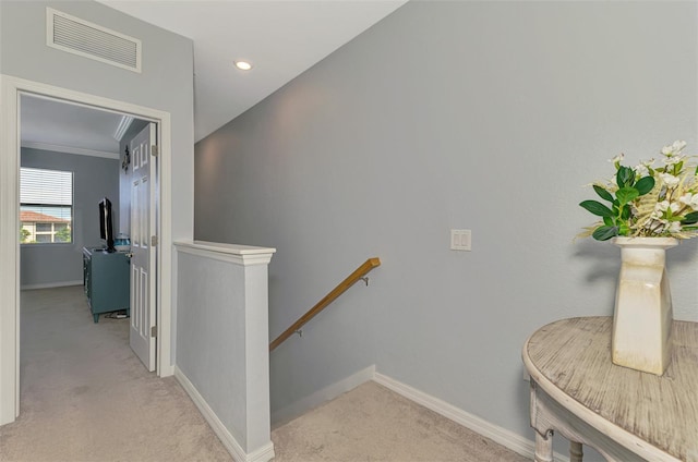 interior space with visible vents, crown molding, baseboards, and carpet floors
