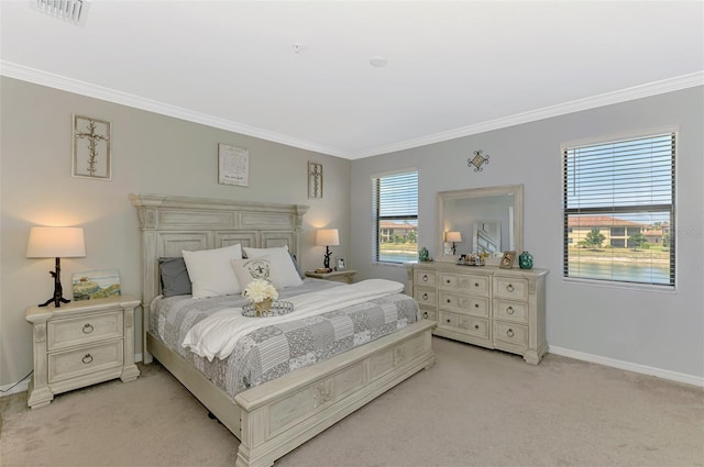 bedroom with crown molding, light colored carpet, baseboards, and visible vents