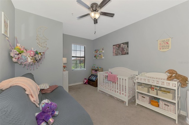 carpeted bedroom with baseboards and a ceiling fan