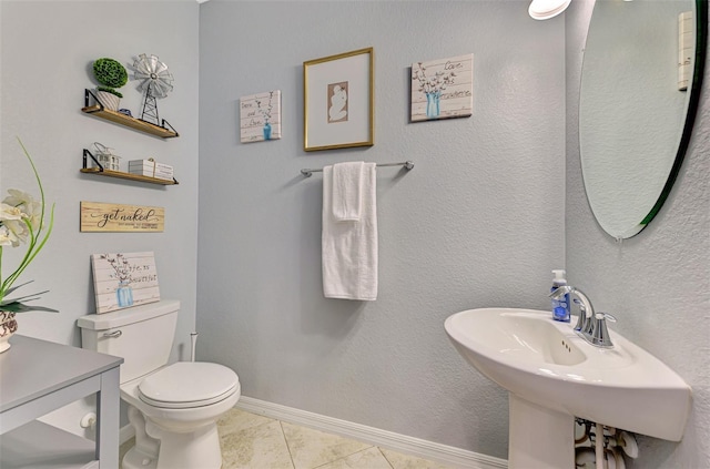 bathroom featuring toilet, baseboards, and tile patterned flooring