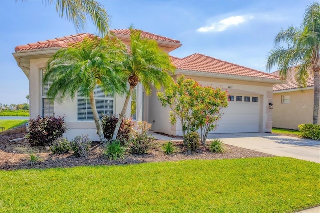 mediterranean / spanish house featuring concrete driveway, stucco siding, and a garage