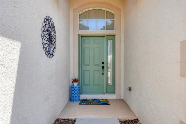 view of exterior entry featuring stucco siding